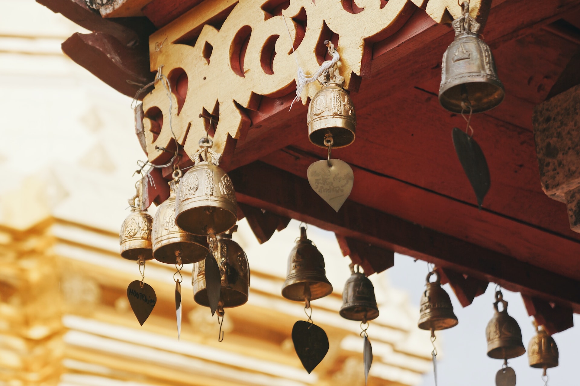 Lots of small bells hanging from the roof of a Thai temple